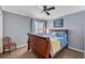 Cozy bedroom with blue accents, ceiling fan, and comfortable queen-sized bed at 5608 Rockfield Loop, Valrico, FL 33596