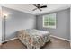Cozy bedroom with a ceiling fan, a comfortable bed, and a window for natural light at 5608 Rockfield Loop, Valrico, FL 33596