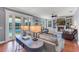 Relaxing living room boasting a fireplace, built-in shelving, hardwood floors, and pool access at 5608 Rockfield Loop, Valrico, FL 33596
