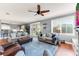 Spacious living room featuring hardwood floors, natural light, plush seating, and access to the pool area at 5608 Rockfield Loop, Valrico, FL 33596