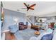 Open-concept living room with fireplace, hardwood floors, plush seating, and natural light at 5608 Rockfield Loop, Valrico, FL 33596