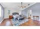 Elegant main bedroom with hardwood floors, accent wall, and stylish furniture at 5608 Rockfield Loop, Valrico, FL 33596