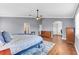 Spacious main bedroom with hardwood floors, walk-in closet access, and neutral decor at 5608 Rockfield Loop, Valrico, FL 33596