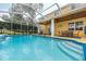 Inviting screened-in pool area with a covered patio and comfortable seating at 5608 Rockfield Loop, Valrico, FL 33596