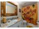Stylish bathroom with a vanity and sunflower-themed shower curtain at 9341 Blind Pass Rd, St Pete Beach, FL 33706
