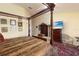 Spacious bedroom features a four-poster bed, TV, wood floors and furniture at 9341 Blind Pass Rd, St Pete Beach, FL 33706