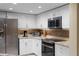 Modern kitchen features stainless steel appliances, granite countertops, and ample cabinet space at 9341 Blind Pass Rd, St Pete Beach, FL 33706