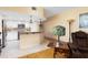 Charming living room flows into modern kitchen with breakfast bar and granite countertops at 9341 Blind Pass Rd, St Pete Beach, FL 33706