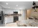 Modern kitchen features stainless steel appliances, granite countertops, and ample cabinet space at 9341 Blind Pass Rd, St Pete Beach, FL 33706