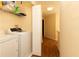 Laundry room with white washer and dryer, shelving and storage space at 9341 Blind Pass Rd, St Pete Beach, FL 33706
