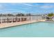 Beautiful waterfront pool with boat dock and spa overlooking tranquil water views at 9341 Blind Pass Rd, St Pete Beach, FL 33706