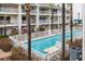 Inviting community pool surrounded by well-maintained condos and lush palm trees at 9341 Blind Pass Rd, St Pete Beach, FL 33706