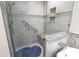 Updated shower with glass doors, mosaic tile accents, and a built-in bench at 9341 Blind Pass Rd, St Pete Beach, FL 33706