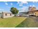 Landscaped backyard with a shed, playset, screened-in pool area, and plenty of green space at 11001 Hobson St, Spring Hill, FL 34608