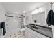Bathroom with a shower-tub combination, modern fixtures, and ample natural light at 11001 Hobson St, Spring Hill, FL 34608