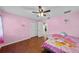Cozy bedroom features a double closet, hardwood floors, and view to another room at 11001 Hobson St, Spring Hill, FL 34608