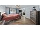 Bedroom featuring wood floors, pool view, TV, dresser, and an ensuite bathroom for added convenience at 11001 Hobson St, Spring Hill, FL 34608