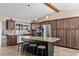 Gourmet kitchen with a central island, granite countertops, stainless steel appliances, and ample storage at 11001 Hobson St, Spring Hill, FL 34608
