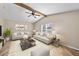 Spacious living room with vaulted ceiling, wood beam, neutral decor, and plenty of natural light at 11001 Hobson St, Spring Hill, FL 34608