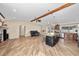 Open-concept living space with a modern kitchen island, cozy seating, and stylish wood-look flooring at 11001 Hobson St, Spring Hill, FL 34608