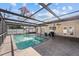 Inviting pool and patio area with screened enclosure, lounge seating, and clear water at 11001 Hobson St, Spring Hill, FL 34608