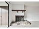 Classic fireplace with stone base and wooden mantle in a room with neutral carpeting and white walls at 130 Lakeview Way # 130, Oldsmar, FL 34677