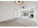 Spacious living room with neutral carpet, fireplace, ceiling fan and sliding door to patio at 130 Lakeview Way # 130, Oldsmar, FL 34677