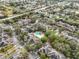 Community aerial view showcasing townhomes surrounding a sparkling pool and lush landscaping at 2160 Chianti Pl # 11-0117, Palm Harbor, FL 34683