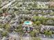 An aerial view of a community featuring a pool, mature landscaping, and ample parking at 2160 Chianti Pl # 11-0117, Palm Harbor, FL 34683