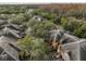 Aerial view of clustered roofs with surrounding trees and streetscape at 2160 Chianti Pl # 11-0117, Palm Harbor, FL 34683