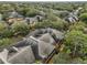 Aerial view of roof tops surrounded by trees in the community at 2160 Chianti Pl # 11-0117, Palm Harbor, FL 34683