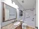 Bathroom with granite countertop, tiled shower, and bronze fixtures at 2160 Chianti Pl # 11-0117, Palm Harbor, FL 34683