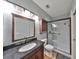 Well-lit bathroom with glass shower, wood vanity and granite countertop at 2160 Chianti Pl # 11-0117, Palm Harbor, FL 34683