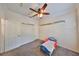 Neutral bedroom featuring a ceiling fan, closet, and gray carpet at 2160 Chianti Pl # 11-0117, Palm Harbor, FL 34683