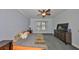 Spacious bedroom features ceiling fan, large window, soft carpet, dresser and a comfortable bed at 2160 Chianti Pl # 11-0117, Palm Harbor, FL 34683
