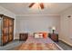 This large bedroom features soft carpet, a ceiling fan, and and nightstands flanking a bed at 2160 Chianti Pl # 11-0117, Palm Harbor, FL 34683