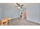 Cozy bedroom features a ceiling fan and leads to an ensuite bathroom and hallway at 2160 Chianti Pl # 11-0117, Palm Harbor, FL 34683