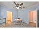 Bedroom featuring blue walls, ceiling fan, mirror, and gray carpet at 2160 Chianti Pl # 11-0117, Palm Harbor, FL 34683