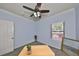 Bedroom featuring blue walls, ceiling fan, window, and gray carpet at 2160 Chianti Pl # 11-0117, Palm Harbor, FL 34683