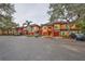 Exterior view of townhomes with attached garages and well-maintained landscaping at 2160 Chianti Pl # 11-0117, Palm Harbor, FL 34683