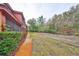Exterior view of building with manicured bushes, walkway, and lush trees at 2160 Chianti Pl # 11-0117, Palm Harbor, FL 34683