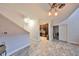 Hallway with beautiful flooring that leads to a kitchen with dark cabinets and granite countertops at 2160 Chianti Pl # 11-0117, Palm Harbor, FL 34683