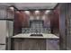 Updated kitchen features stainless steel appliances, dark cabinets, and granite countertops at 2160 Chianti Pl # 11-0117, Palm Harbor, FL 34683