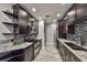 Updated kitchen featuring stainless steel appliances, dark cabinets, and granite countertops at 2160 Chianti Pl # 11-0117, Palm Harbor, FL 34683