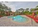 A community pool with lounge chairs and mature landscaping at 2160 Chianti Pl # 11-0117, Palm Harbor, FL 34683