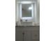 Clean bathroom with a white vanity, vessel sink, and backlit mirror providing bright illumination at 3303 Brigadoon Dr, Clearwater, FL 33759