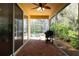 Inviting back patio featuring brick pavers, a grill, outdoor lights and a view of the screened-in pool at 587 Lakewood Dr, Oldsmar, FL 34677