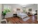 Serene bedroom with large windows, hardwood floors, and a comfortable seating area at 587 Lakewood Dr, Oldsmar, FL 34677