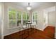 Charming breakfast nook with plantation shutters offering views of outdoor greenery and light hardwood floors at 587 Lakewood Dr, Oldsmar, FL 34677