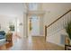 Bright foyer featuring tile flooring, high ceilings, staircase, and views to the entry door and sitting room at 587 Lakewood Dr, Oldsmar, FL 34677